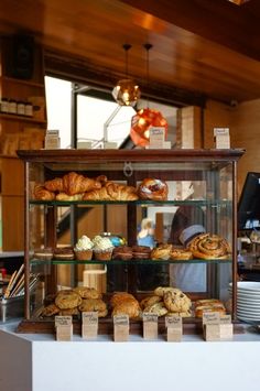 an assortment of baked goods on display in a bakery