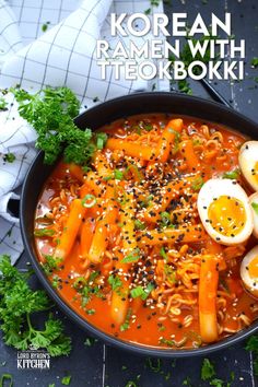 a bowl filled with ramen and boiled eggs on top of rice, carrots and parsley