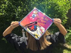 a woman wearing a graduation cap and holding up her hat with the words, i love you