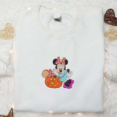 Minnie Mouse And Pumpkin Embroidered Hoodie, Disney Halloween Embroidered Hoodie, Best Halloween Gift Ideas Nestled within the bustling tapestry of fashion, Tinicloset stands as a beacon of creativity and individuality, weaving dreams into fabric and transforming garments into personalized statements of style. As patrons step into our enchanting boutique, they are enveloped in an ambiance that resonates with imagination, offering a kaleidoscope of bespoke embroidered apparel that celebrates uniq Mickey Mouse Long Sleeve Sweatshirt For Fall, White Disney Character Print Sweatshirt For Fan Events, Minnie Mouse Long Sleeve Cotton Hoodie, Minnie Mouse Cotton Long Sleeve Hoodie, Cotton Long Sleeve Minnie Mouse Hoodie, Mickey Mouse Hooded Sweatshirt For Fall, Hooded Mickey Mouse Sweatshirt For Fall, White Disney Sweatshirt For Fall, Disney Long Sleeve Halloween Sweatshirt