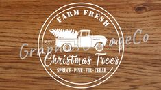 the logo for farm fresh christmas trees on a wooden surface with white lettering that reads,