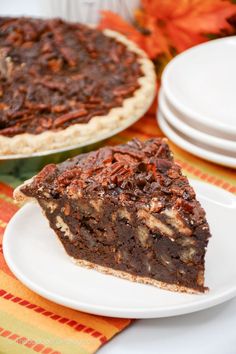 a slice of pecan pie sitting on top of a plate next to another pie