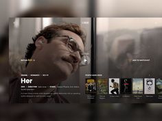 an image of a man with glasses looking at the screen on his tv set that is showing movies