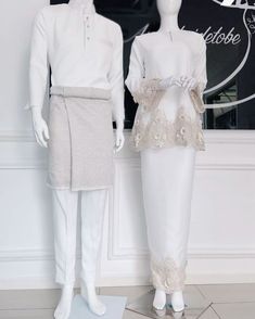 two mannequins dressed in white and grey clothing, one wearing a dress