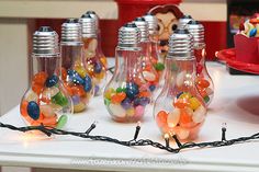 some candy in glass bottles on a table