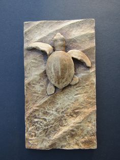 a stone sculpture with a turtle on it's back