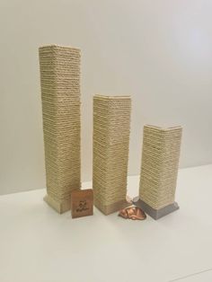 three vases made out of jute stacked on top of each other with a small piece of copper in the middle