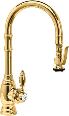 a kitchen faucet with gold colored fixtures