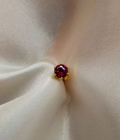 22k solid gold ear studs / karabu earring with red/ruby coloured Cubic zirconia. The stone is available in 2mm, 2.5mm and 3mm size. This Cubic Zirconia has AAAAA rating. This earring comes with screw back closure. Our 22k jewelleries are genuine real gold. This is a special gift for baby, child, girlfriend, wife, daughter, mum, family or friend. It is a perfect gift for Christmas, New year, Valentines day, christening, birthday, wedding, anniversary and any special occasion.. Each item is packag Dainty Prong Setting Nose Studs As Gifts, Elegant Tiny Round Nose Studs, Elegant 14k Gold Nose Ring As Gift, Internally Threaded Yellow Gold Fine Jewelry, 22k Gold Red Jewelry, Classic Round Nose Studs For Gifts, 14k Gold Nose Studs With Prong Setting Gift, 14k Gold Prong Setting Nose Studs For Gift, Round Internally Threaded Nose Rings For Gifts