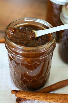 a jar filled with brown sauce on top of a table