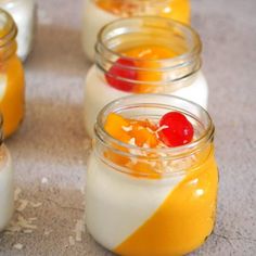 small jars filled with fruit and yogurt sit on the floor next to each other