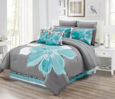 a bed with blue and gray flowers on it