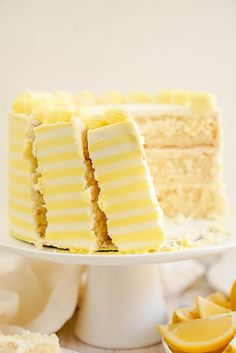 there is a white cake with lemons on the side