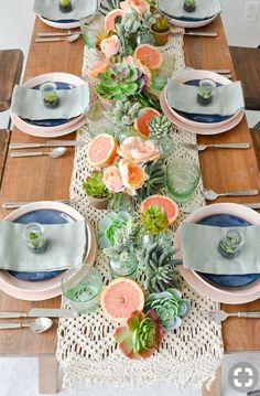 the table is set with succulents and plates