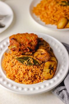 a white plate topped with rice and meat