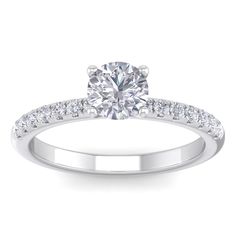 a white gold engagement ring with diamonds on the band and a round cut diamond in the center