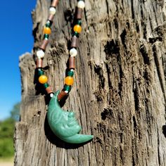 This knotted necklace has a wonderful African tribal vibe with it's green quartz, orange carnelian, white mother of pearl and brown wood color theme. The smiling Man in the Moon pendent made of green aventurine is believed to bring abundance, good luck and opportunity and completes the bohemian and overall masculine feel of this piece. Earthy Green Necklace For Festivals, Earthy Green Necklace For Festival, Nature-inspired Green Necklace For Festival, Nature-inspired Green Necklace For Festivals, Green Hand Wrapped Nature-inspired Necklaces, Bohemian Aventurine Beaded Necklaces, Green Hand Wrapped Nature-inspired Necklace, Earthy Green Necklace With Wooden Beads, Bohemian Aventurine Beaded Necklace