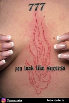 a woman's chest with tattoos on it and the words 777 you look like success