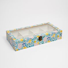 an empty jewelry box with floral designs on it