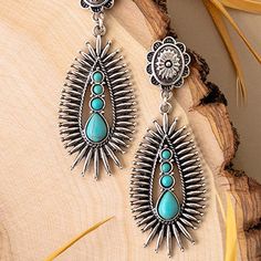 Introducing the Get To The Point Earrings, a timeless piece of jewelry with an exquisite western squash blossom design. These 3" earrings are made from a combination of Turquoise and silver or copper and ivory, with a stamped detailed post back attached to a rowel-like design featuring stone detail. An elegant and tasteful statement, these earrings bring refinement to any outfit. 3 Earrings, Squash Blossom, Blossom Design, Sterling Jewelry, Glitz And Glam, Plus Dresses, Accessories Rings, 2 Colours, Holiday Fun