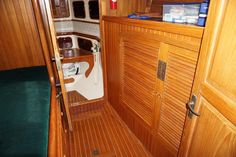 the inside of a small boat with wood paneling and green carpet on the floor