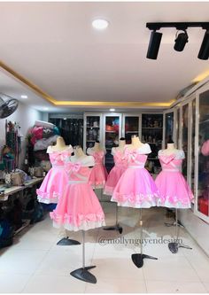 pink dresses on mannequins in a clothing store