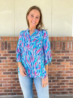 This eye-catching top will make waves with its bright, multi-color print. Its 3/4 sleeves and wrinkle-resistant fabric make it a practical choice for any occasion. Ride the tidal wave of style with this playful and practical top. Multicolor Half Sleeve Tops For Beach, Trendy Abstract Print Blouse For Beach, Trendy Beach Blouse With Abstract Print, Trendy Blue Abstract Print Top, Trendy Blue Top With Abstract Print, Multicolor 3/4 Sleeve Blouse For Vacation, Multicolor 3/4 Sleeve Vacation Blouse, Versatile Multicolor Tops For Spring, Blue Trendy Top With 3/4 Sleeves