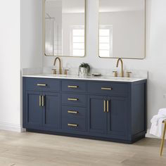 a bathroom vanity with two mirrors above it