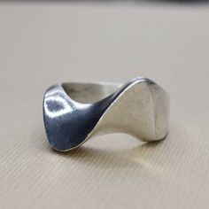 Vintage sterling silver modernist wave design ring. Signed MEXICO. Era: c.1970s Markings: MEXICO 925 Material: Sterling Silver Ring Size: 9.5 (Comes with one free resizing by our jeweler) Weight: 15.1 grams Condition: Good vintage condition with minor surface wear from age  Shipping is free in the United States  Follow us on Instagram @LUXXORVintage Wax Casted Jewelry, Modern Wavy Rings With Polished Finish, Modern Silver Wavy Rings, Modernist Sterling Silver Rings, Wave Rings, Silver Ring Design, Rabbit Ring, Wide Silver Ring, Wax Ring