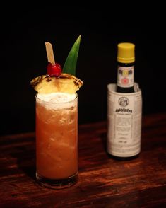 a pineapple and rum cocktail on a wooden table