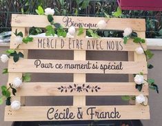 a wooden sign with flowers on it that says, merci d'ere avec nous