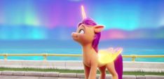 an animated pony standing on top of a sidewalk next to the ocean in front of a rainbow colored sky