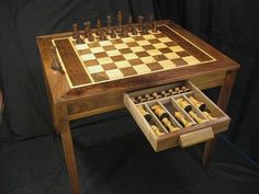 a wooden chess set with its drawers open