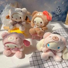 four stuffed animals sitting on top of a table