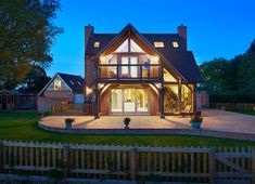 a large house lit up at night in the evening