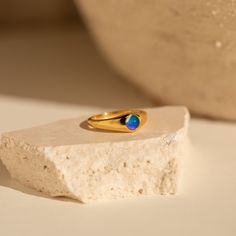 Love our classic mood ring but want something a little more subtle? Our Mini Signet Mood Ring is minimalist with a thinner band and smaller stone than the classic. This more delicate option is great to pair with other stacking rings in your collection. Material: High Quality Solid 925 Sterling Silver Finish: 18K Gold Featuring a ~1.5mm to ~6.5mm Thick Band with a ~4.5mm Mood Stone Model showcases a minimalist, refined look featuring our Dome Ring, Minimal Stacking Ring, and Beaded Ring. SKU: RR- Everyday Stackable Opal Ring, Minimalist Gold Opal Rings, Minimalist Round Band Crystal Ring For Everyday, Minimalist Open Signet Ring With Birthstone, Minimalist Gold Birthstone Ring With Gemstone, Minimalist Gold Opal Birthstone Ring, Stackable Open Opal Ring In Fine Jewelry Style, Minimalist Yellow Gold Moonstone Ring For Everyday, Modern Gold Opal Rings