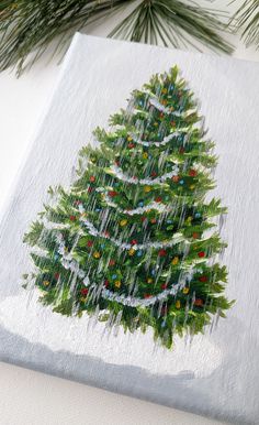 a painting of a christmas tree on a white surface with pine branches in the background