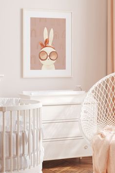 a baby's room with a white crib, rocking chair and framed art