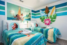 two beds in a hotel room with blue and green striped walls, one has a painting on the wall