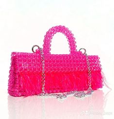 This soft pink beaded bag is enhanced by delicate feathers that adorn its edges, adding a whimsical and ethereal touch with elegance to the accessory. With its combination of beads and feathers, this bag is a stunning statement piece, perfect for adding a touch of glamour to any outfit or occasion. Our pink feather beaded bag called "Ada," an igbo word meaning first daughter. "Ada" adds a cultural touch, symbolizing pride and responsibility within the family. Luxury Formal Bag With Beaded Fringe, Elegant Pink Beaded Bag, Pink Beaded Formal Bags, Rectangular Party Bag With Beaded Fringe, Formal Pink Beaded Bags, Rectangular Party Bags With Beaded Fringe, Party Clutch Bag With Beaded Fringe, Party Clutch Bags With Beaded Fringe, Beaded Fringe Clutch For Party