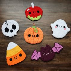 halloween decorations made out of felt on a wooden table