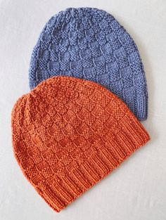 two knitted hats sitting on top of each other