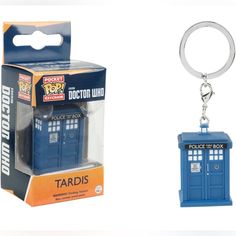 a blue police box keychain with a doctor who logo on the front and inside