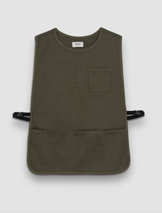 an army green apron with black straps and pocket on the front, in front of a gray background