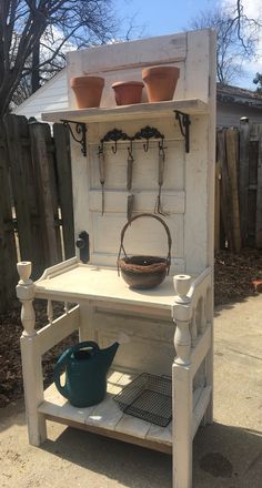 an old fashioned potting bench with pots on it