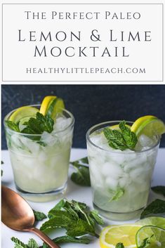 two glasses filled with lemon and lime mojiti on top of a white table