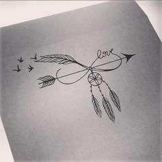 an arrow with the word love written on it and two birds flying around in the sky