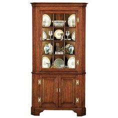 a wooden china cabinet with glass doors