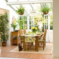 an advertisement for a small conservatory with dining room furniture and potted plants on the windowsill