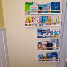 the bookshelves are filled with children's books in this nursery - themed room